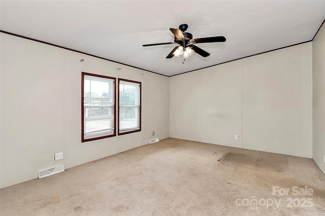 carpeted empty room featuring ceiling fan and a textured ceiling