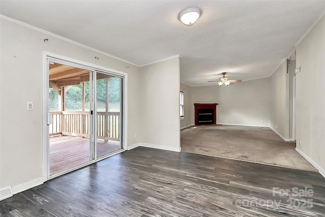 unfurnished living room featuring a textured ceiling, crown molding, ceiling fan, and dark hardwood / wood-style floors