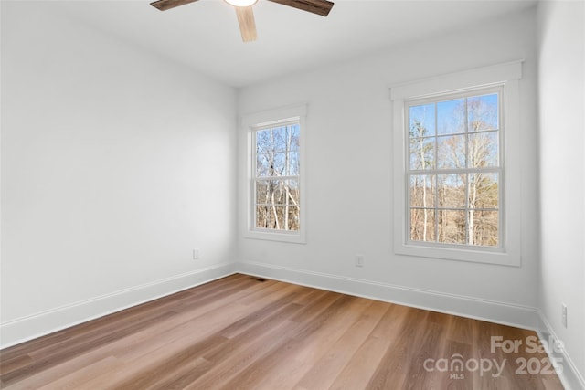 empty room featuring ceiling fan and light hardwood / wood-style floors