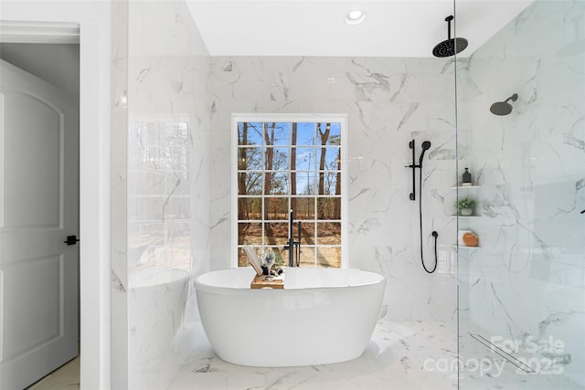 bathroom featuring shower with separate bathtub and tile walls