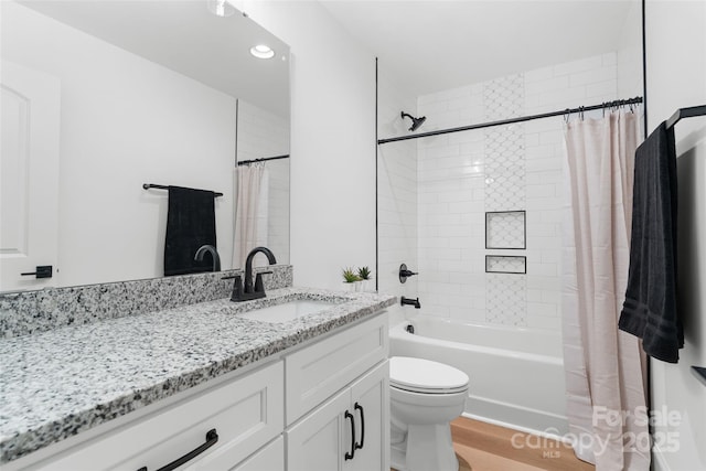 full bathroom with shower / tub combo with curtain, vanity, hardwood / wood-style floors, and toilet