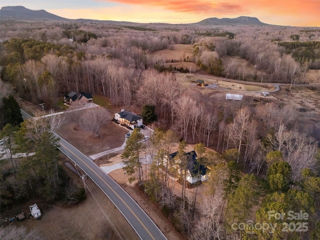 aerial view at dusk featuring a mountain view