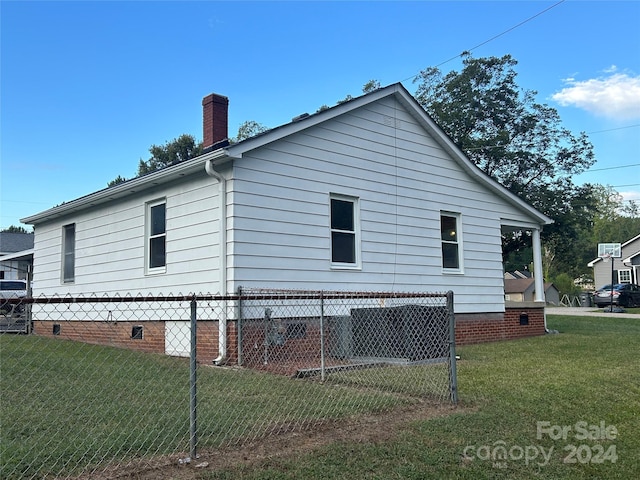 view of side of property with a yard