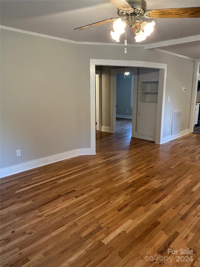 unfurnished room with ceiling fan, dark hardwood / wood-style floors, and crown molding