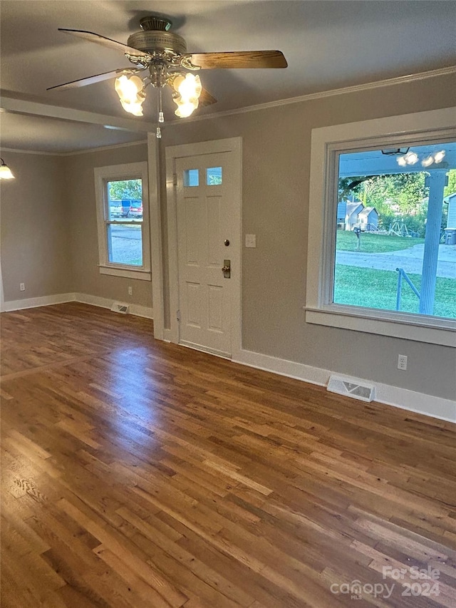 foyer featuring crown molding, dark hardwood / wood-style floors, and ceiling fan