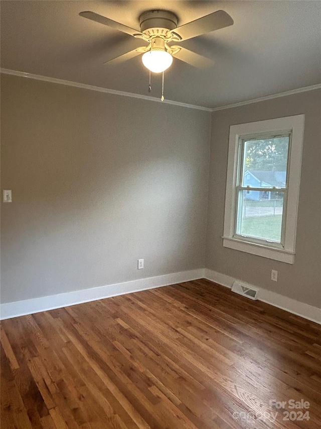 spare room featuring ceiling fan, hardwood / wood-style floors, and crown molding