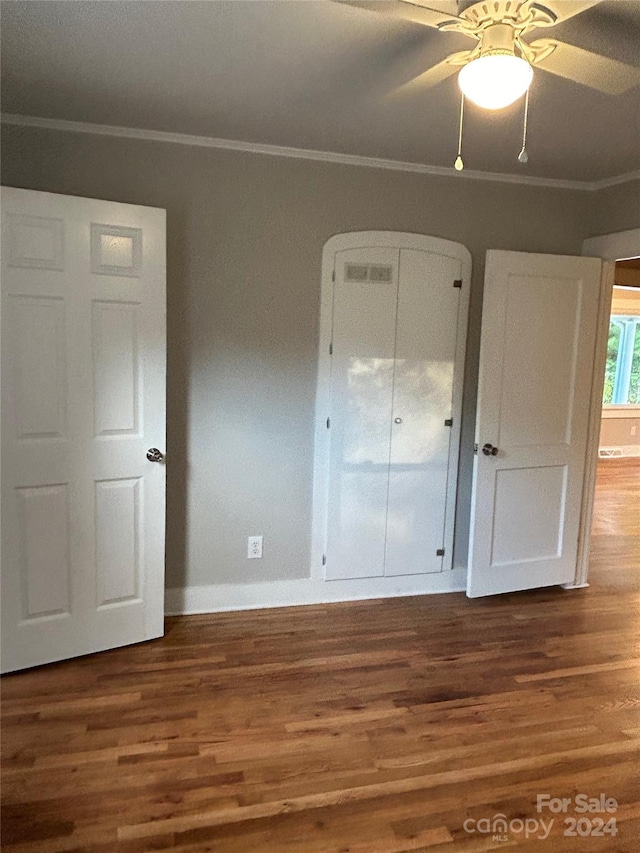 unfurnished bedroom featuring ceiling fan, hardwood / wood-style flooring, and ornamental molding