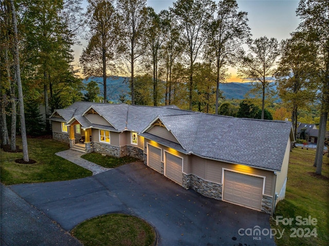 view of front of property with a lawn and a garage