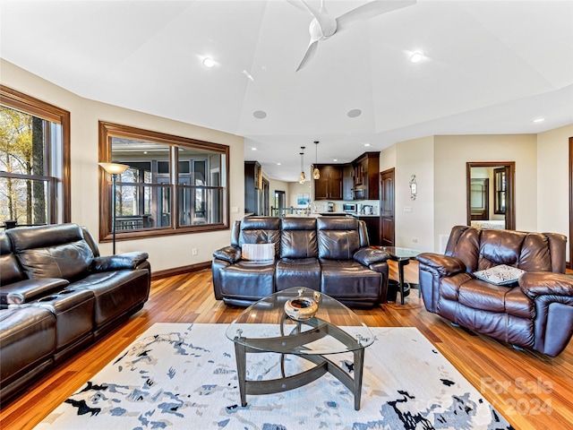 living room featuring light wood-type flooring and ceiling fan