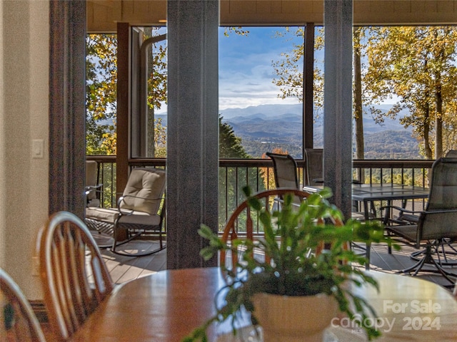 dining space featuring a mountain view and hardwood / wood-style floors