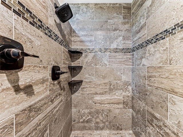 interior details featuring tiled shower