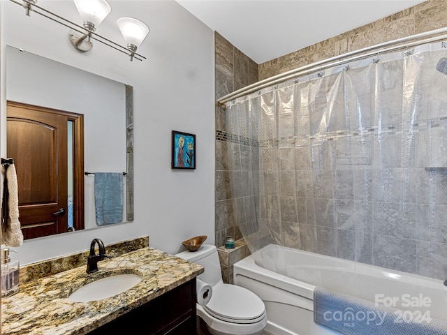 full bathroom featuring shower / tub combo, vanity, and toilet