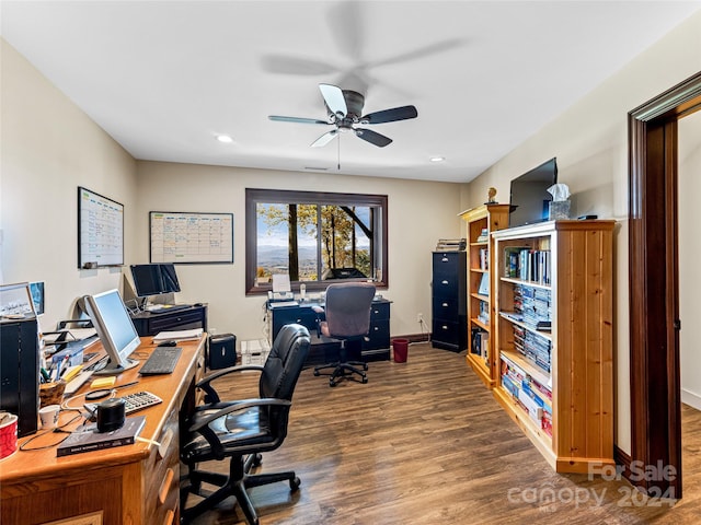 home office featuring wood-type flooring and ceiling fan