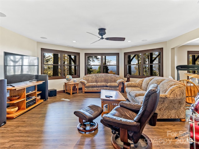 living room featuring ceiling fan, hardwood / wood-style flooring, and a healthy amount of sunlight