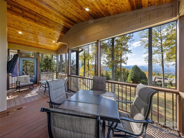 sunroom / solarium featuring wood ceiling and lofted ceiling