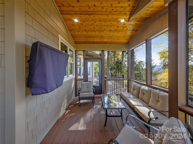 sunroom / solarium with wood ceiling, vaulted ceiling, and plenty of natural light