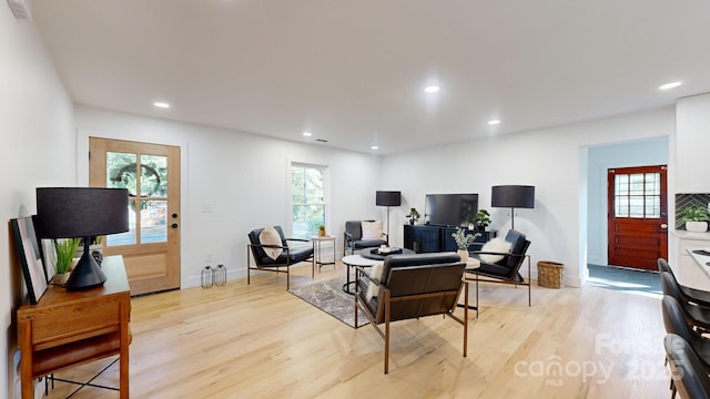 living room with plenty of natural light and light hardwood / wood-style flooring