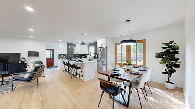 dining room featuring french doors and light hardwood / wood-style floors