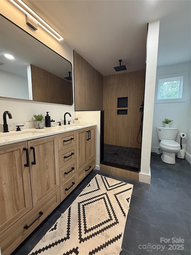 bathroom featuring vanity, tile patterned flooring, toilet, and walk in shower