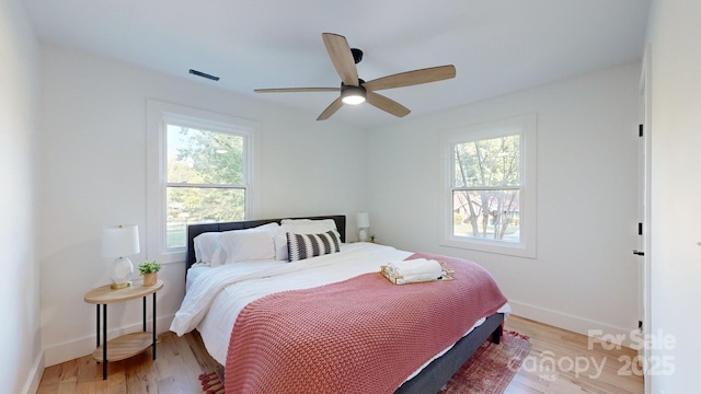 bedroom with light hardwood / wood-style flooring and ceiling fan