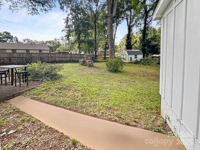 view of yard featuring a storage shed and a patio