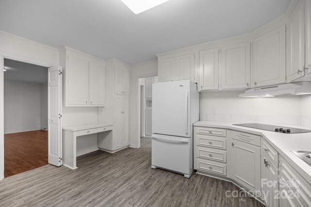 kitchen with light hardwood / wood-style flooring, white cabinetry, white refrigerator, and black electric cooktop