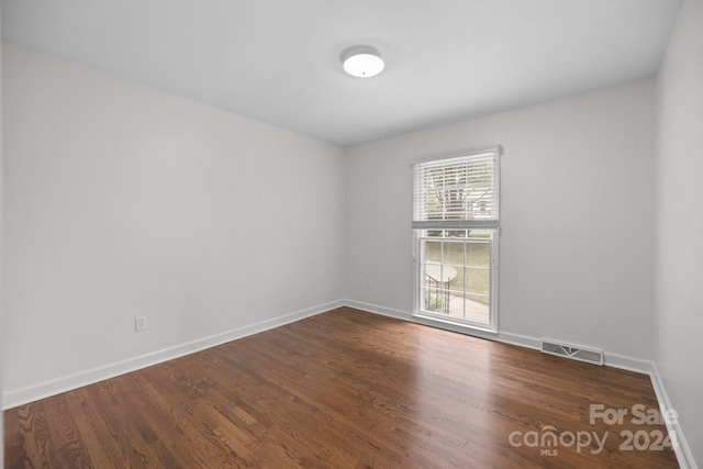 spare room with dark hardwood / wood-style floors