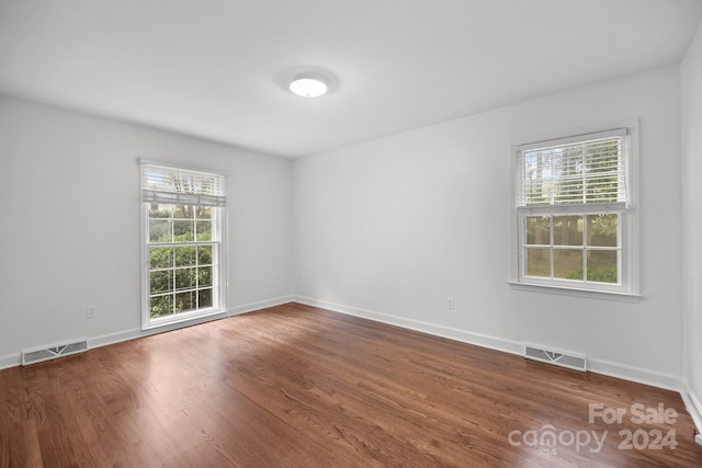 unfurnished room with hardwood / wood-style flooring