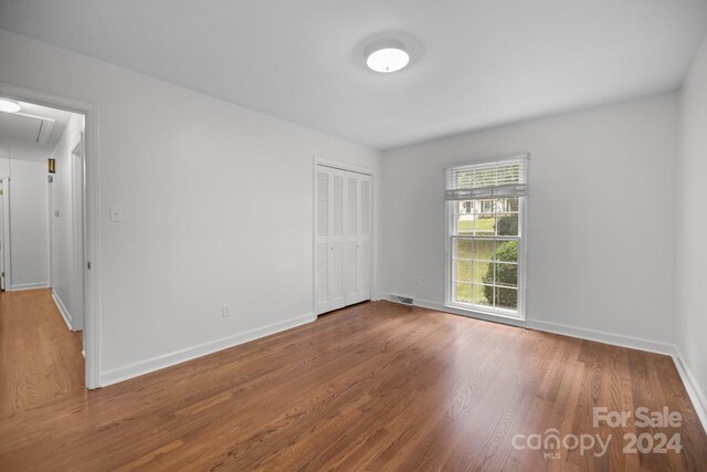 unfurnished room with hardwood / wood-style floors