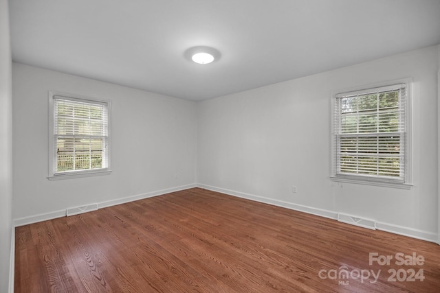 unfurnished room featuring hardwood / wood-style floors