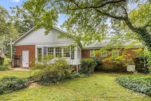 rear view of house with a lawn