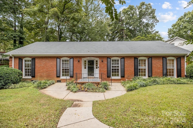 ranch-style house with a front lawn and covered porch