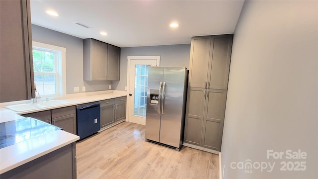 kitchen with gray cabinetry, sink, stainless steel fridge, and dishwasher