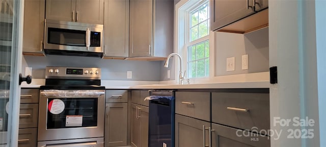 kitchen featuring appliances with stainless steel finishes and gray cabinetry