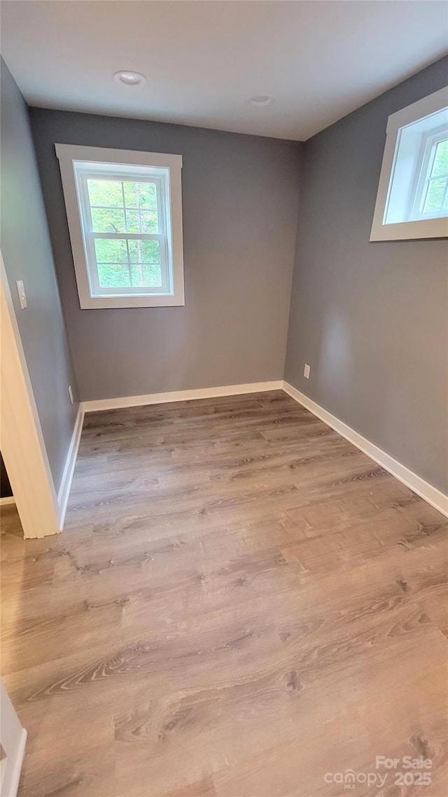 empty room with hardwood / wood-style flooring