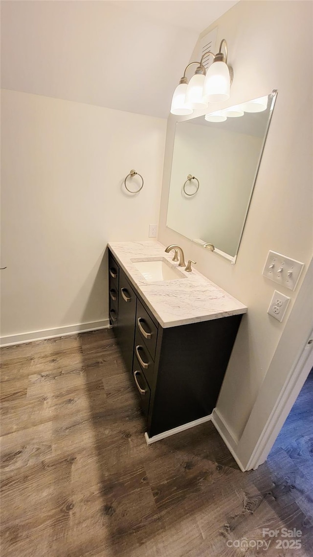 bathroom featuring hardwood / wood-style flooring and vanity