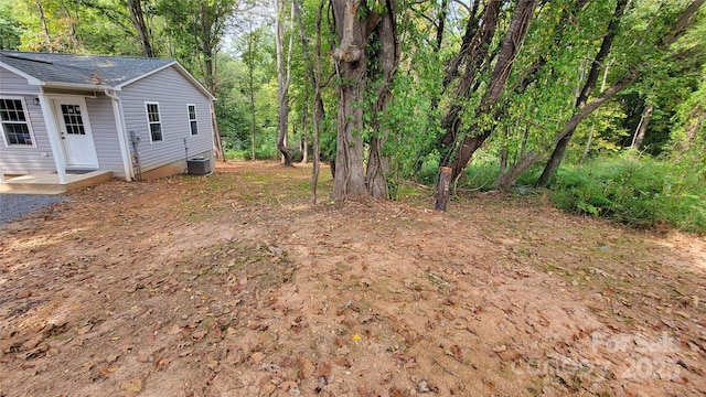 view of yard featuring central air condition unit