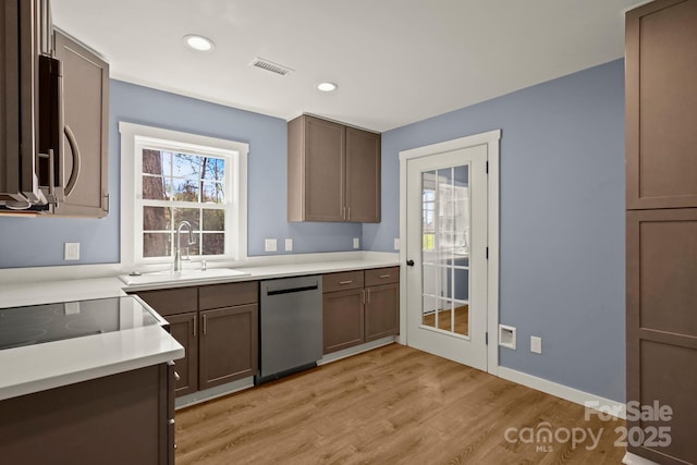 117 Hibriten Mountain Rd SE, Lenoir, NC 28645 - kitchen with visible vents, light wood-style flooring, a sink, stainless steel appliances, and light countertops