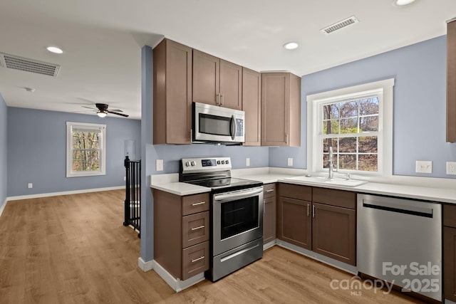 117 Hibriten Mountain Rd SE, Lenoir, NC 28645 - kitchen with a sink, visible vents, light wood finished floors, and stainless steel appliances