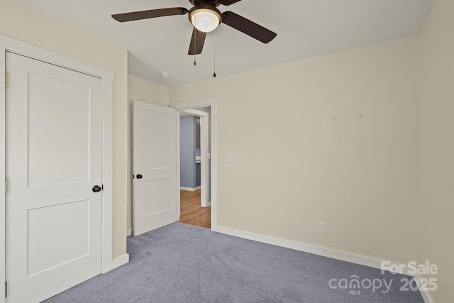 117 Hibriten Mountain Rd SE, Lenoir, NC 28645 - unfurnished bedroom with baseboards, carpet, and a ceiling fan