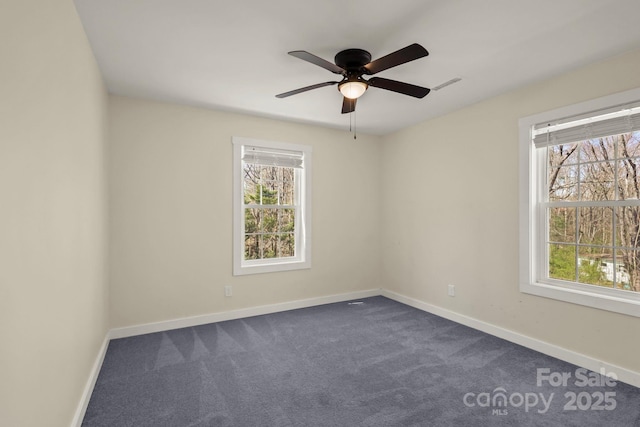 117 Hibriten Mountain Rd SE, Lenoir, NC 28645 - spare room featuring visible vents, baseboards, a ceiling fan, and dark colored carpet