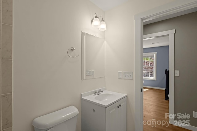 117 Hibriten Mountain Rd SE, Lenoir, NC 28645 - half bathroom with toilet, vanity, and wood finished floors