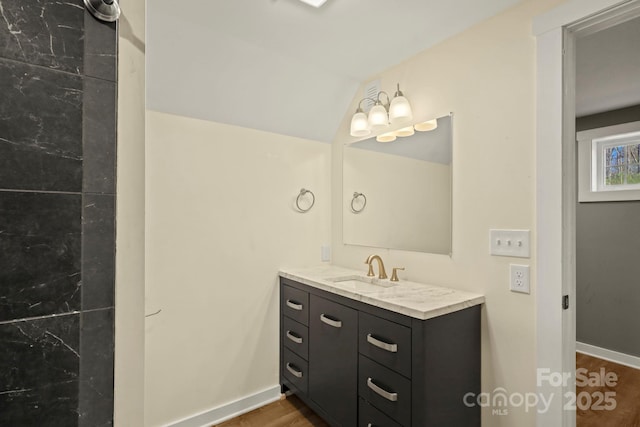 117 Hibriten Mountain Rd SE, Lenoir, NC 28645 - bathroom featuring vanity, lofted ceiling, baseboards, and wood finished floors