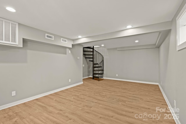 117 Hibriten Mountain Rd SE, Lenoir, NC 28645 - finished basement featuring visible vents, baseboards, light wood-style floors, and stairs
