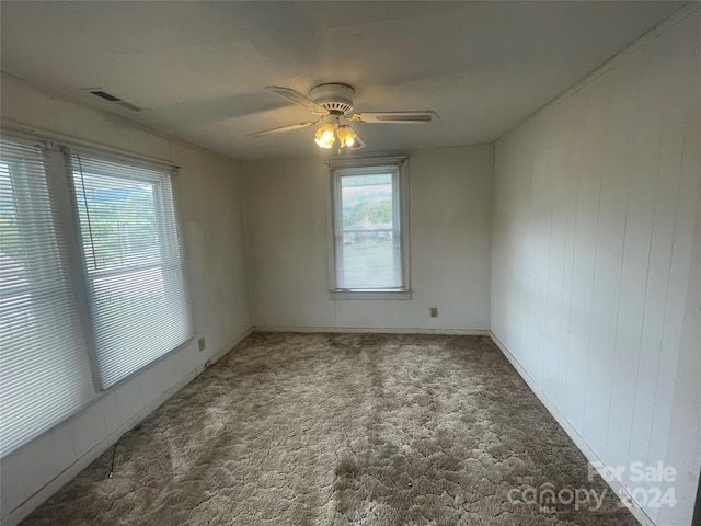 carpeted spare room featuring ceiling fan