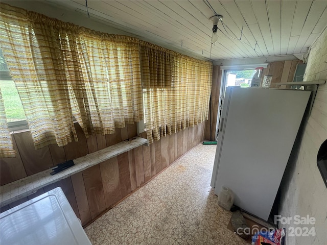 hallway with wooden walls and carpet floors