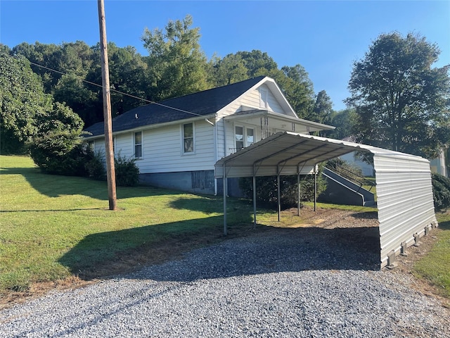 view of side of property with a carport and a yard