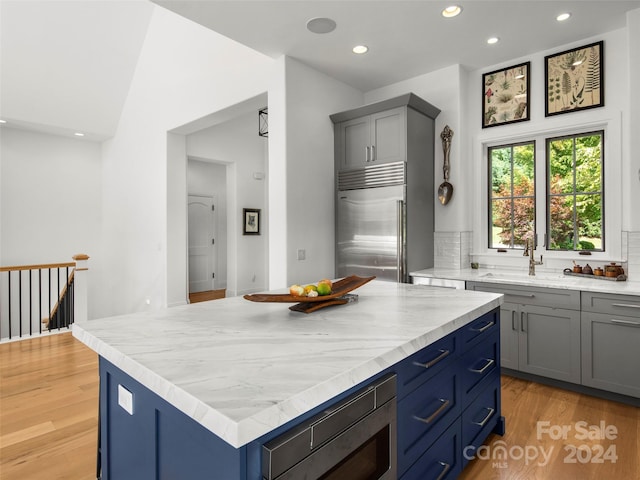 4 Windelsham Way, Arden, NC 28704 - kitchen featuring built in appliances, sink, backsplash, and a kitchen island