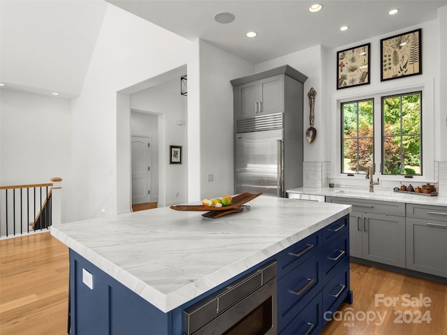 4 Windelsham Way, Arden, NC 28704 - kitchen with built in appliances, a sink, recessed lighting, light wood-type flooring, and blue cabinetry
