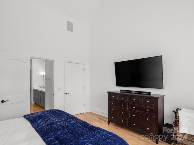 4 Windelsham Way, Arden, NC 28704 - bedroom with ensuite bathroom, light wood-type flooring, and high vaulted ceiling